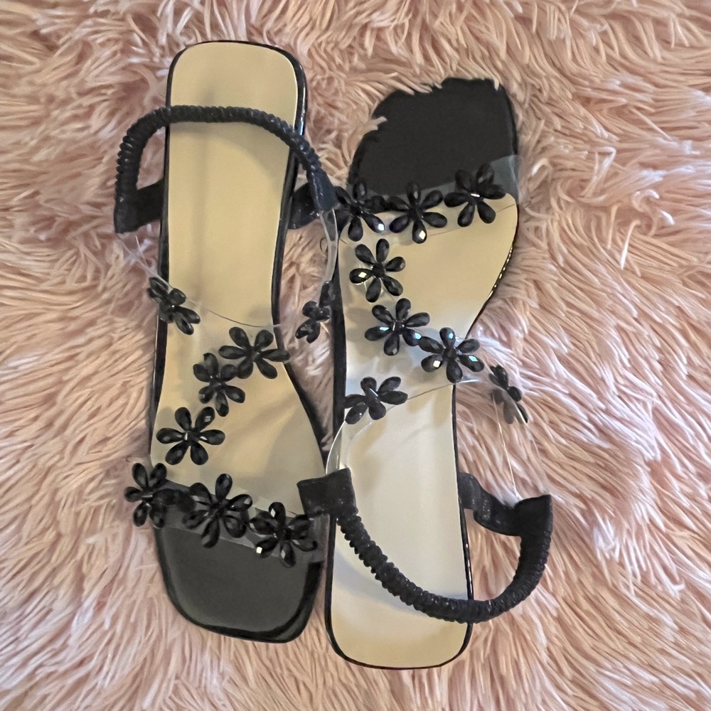 New. Dressy black flower strappy sandals with acrylic heal.
